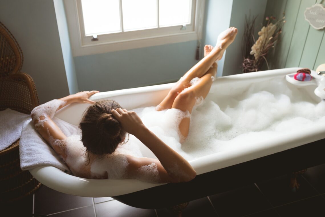 Woman taking a bath in bath tub